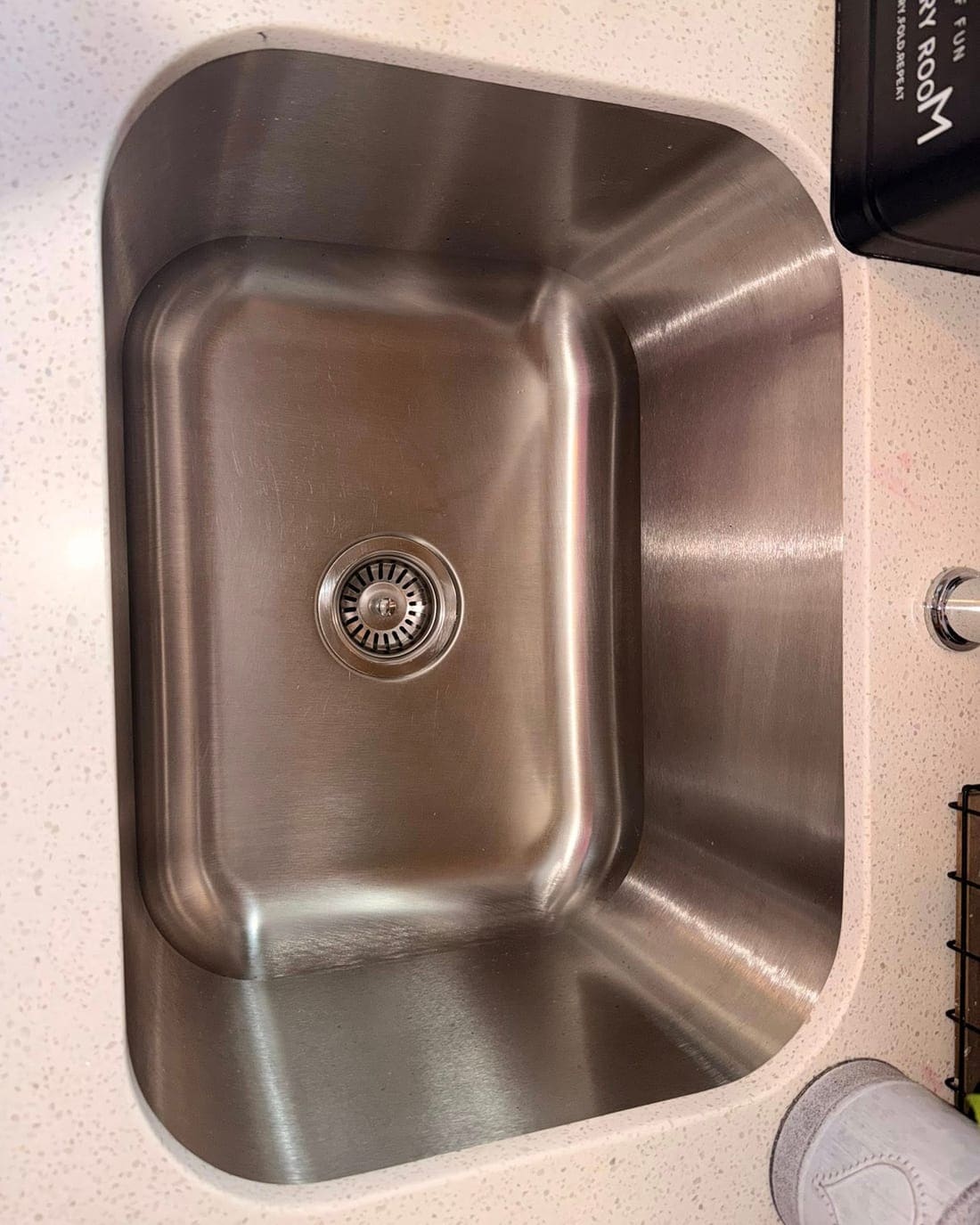 A spotless, polished kitchen sink cleaned by HER Clean Co.