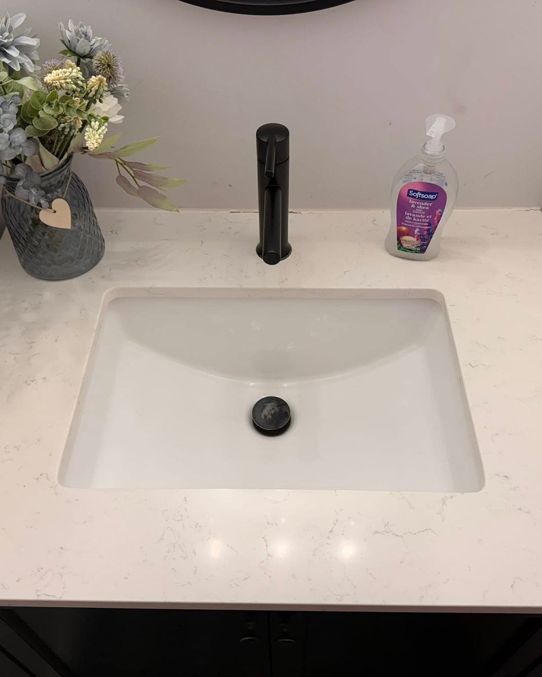 A freshly cleaned, bright bathroom vanity by HER Clean Co.